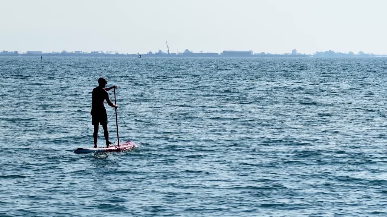 Sportsman paddle boarding in the sea