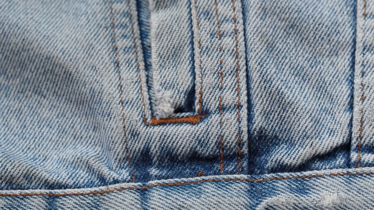 Close-up of Blue Denim Fabric Texture with Seams