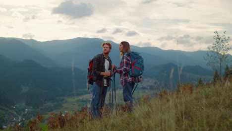 young family hiking together on mountains nature sunset. couple talk on hiking.