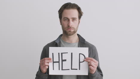 man holding a sign that says help