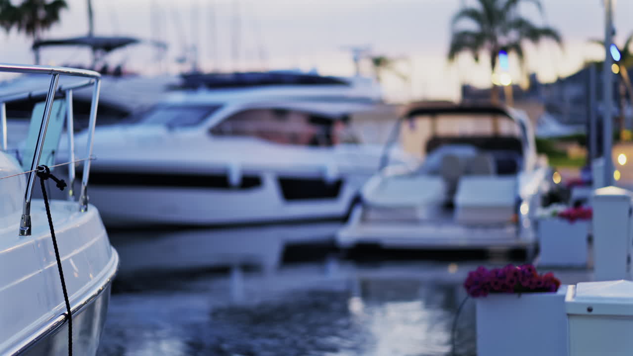 Blurred view of multiple white boats docked in the Port Vauban at sunset in Antibes, France