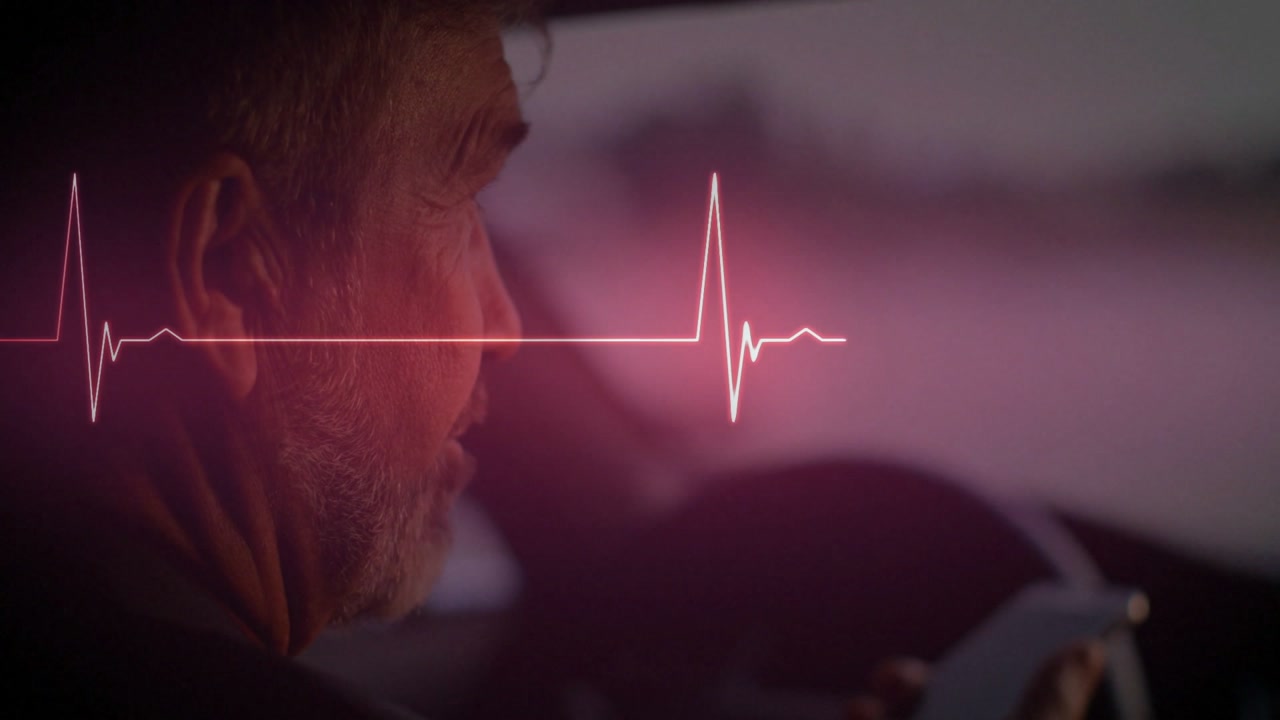 Man driving, heartbeat waveform entering left peaking across profile for health check