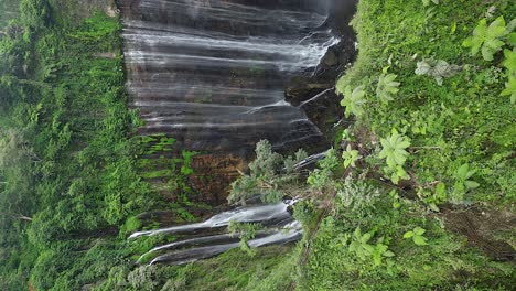 vertical aerial reveals incredible tumpak sewu waterfall on java, idn