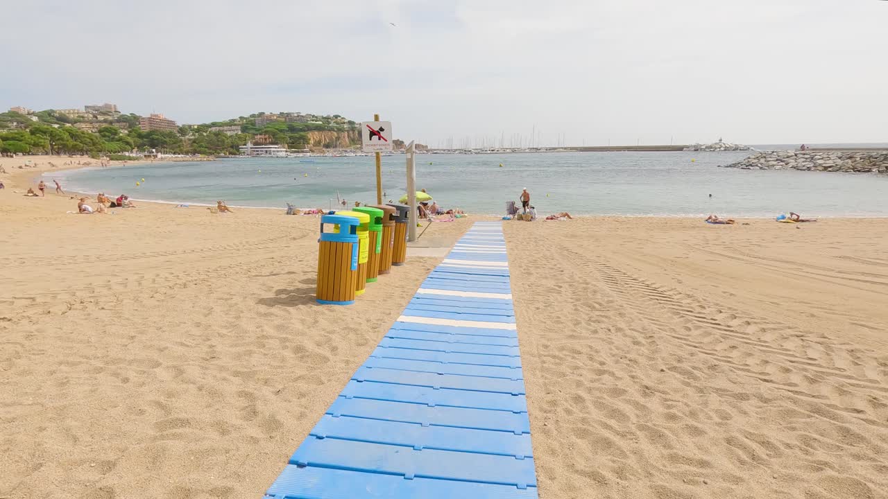 Sant Feliu de Gu&iacute;xols on the Costa Brava of Gerona Spain tourist town there are garbage containers on the beach
