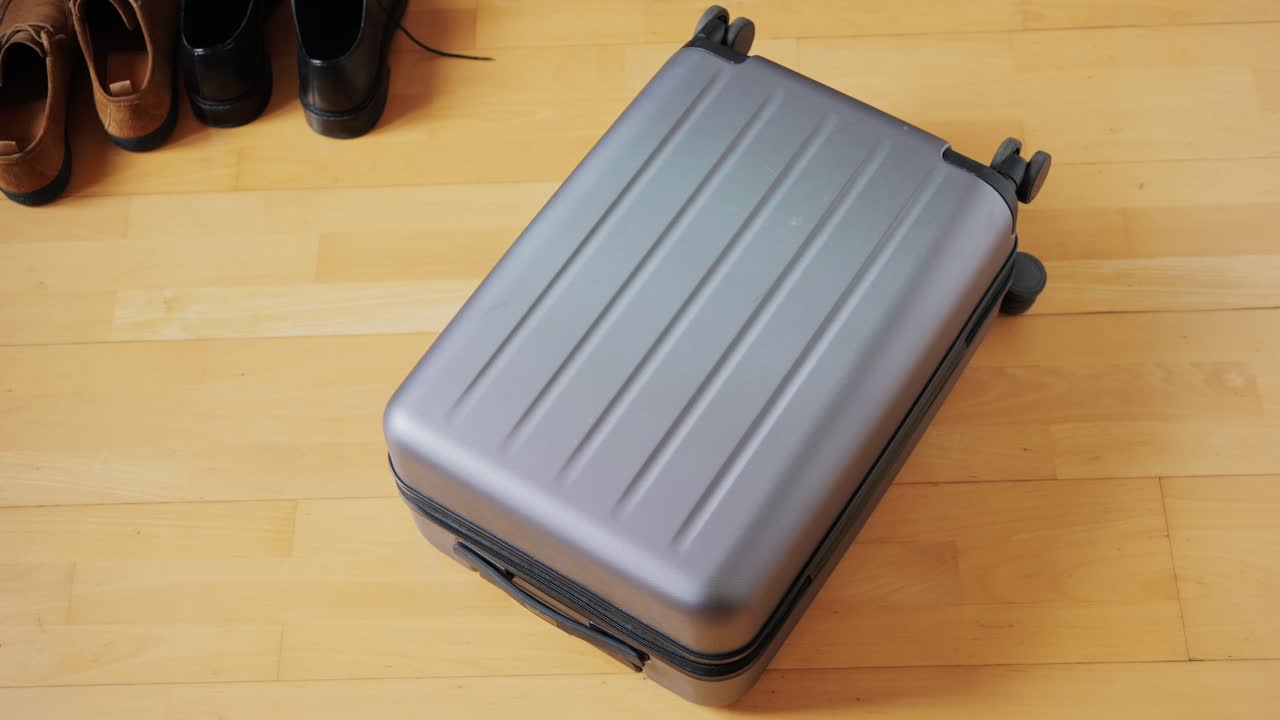 Tourism and travelling concept. Handsome business man going on holiday, packing his suitcase, checking luggage, sitting on bed and looking at packed things