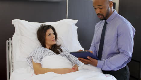 female patient and doctor have consultation in hospital room