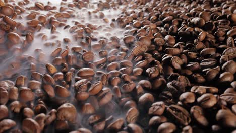 close up of seeds of coffee. fragrant coffee beans are roasted smoke comes from coffee beans.