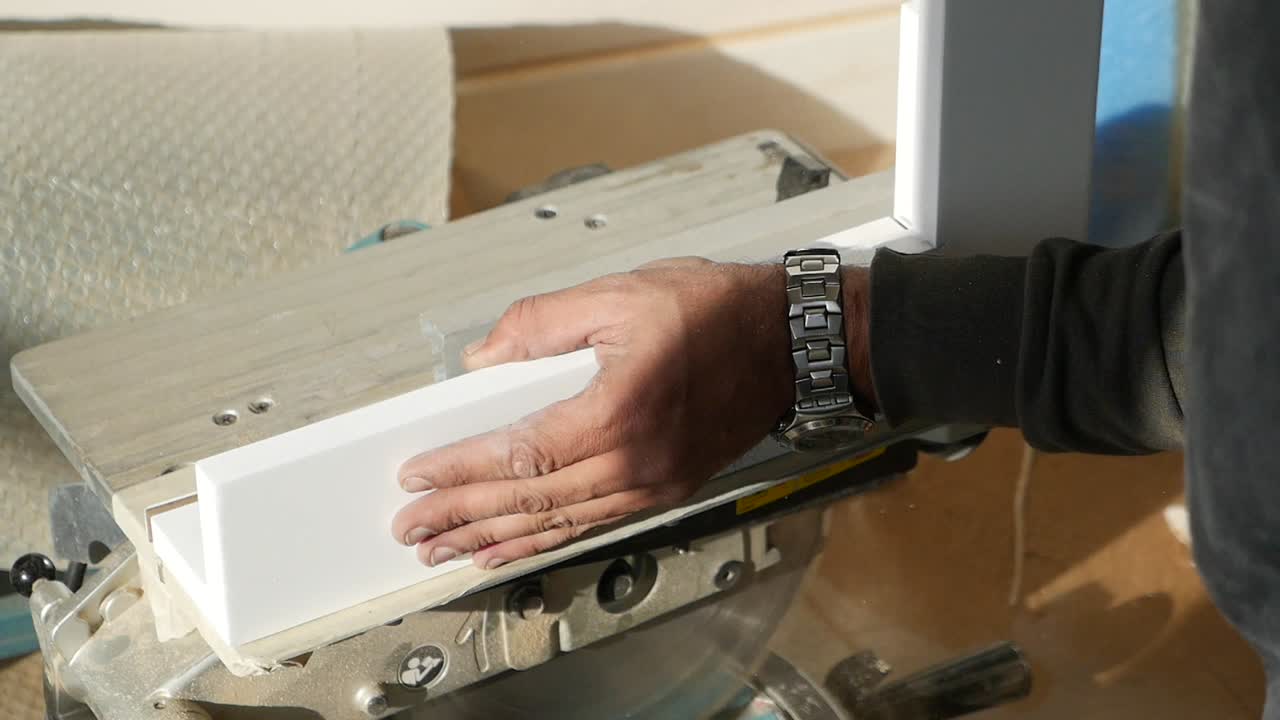 Man cutting wood with a saw