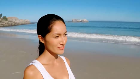 young woman walking on beach