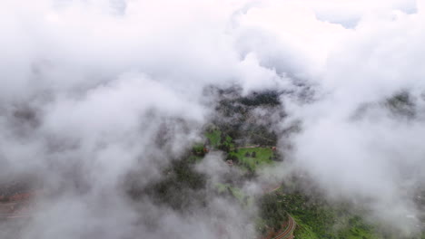 Flight-through-ethereal-puffy-thin-clouds-in-Chautauqua-Park,-Flatirons,-Boulder