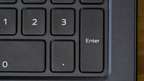 Top-View-Thumb-Pressing-Enter-Keyboard-Button