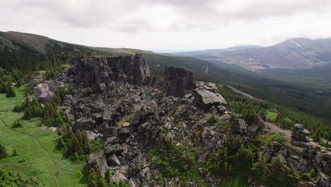 Scenic-aerial-over-rugged-rocky-terrain-on-mountainside,-remote-wilderness