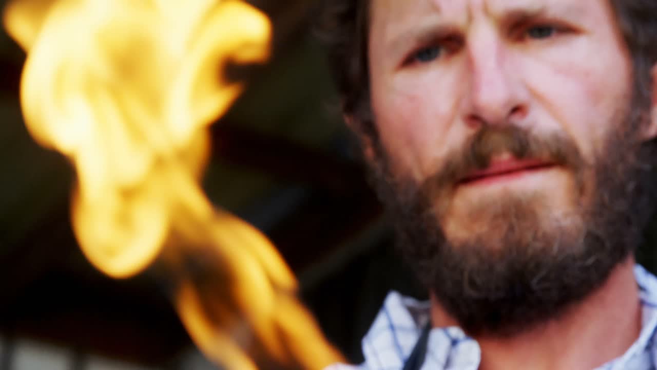 artesano con una antorcha de acetileno en el taller 4k