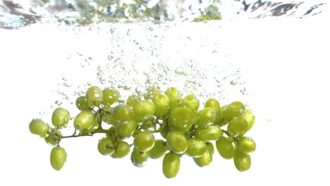 grapes falling into water in super slow motion