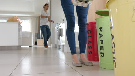 busy diversecouple walking and segregating waste at home, slow motion