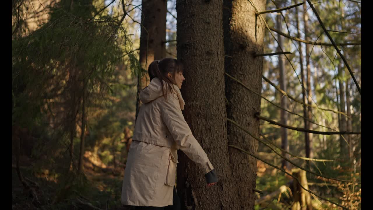 Woman Touching a Tree in the Forest