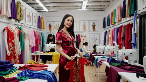 asian fashion designer showcasing an embroidered traditional dress