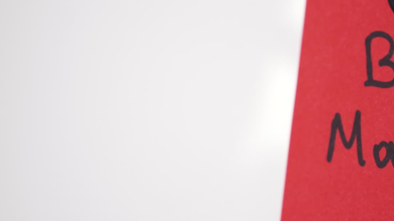 Pan reveal of Bear Market text on red note held by magnet on whiteboard with selective focus