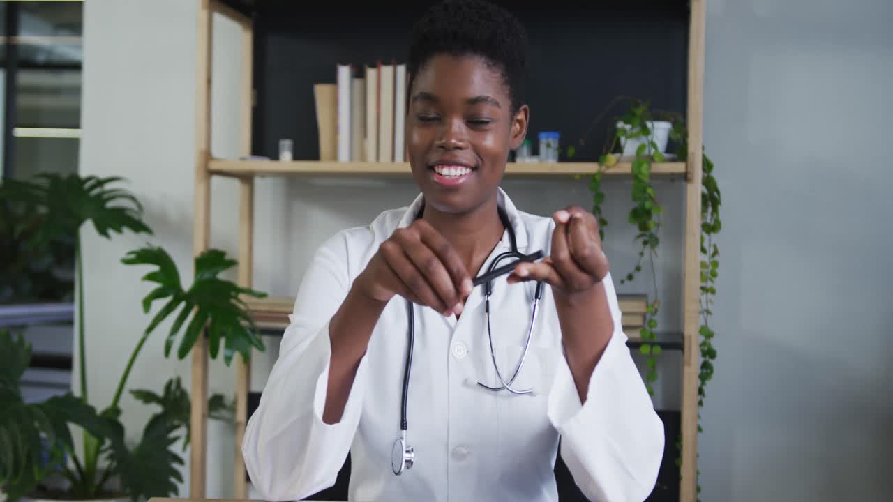 Portrait of african american female doctor having a video chat talking and smiling