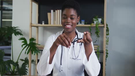 portrait of african american female doctor having a video chat talking and smiling