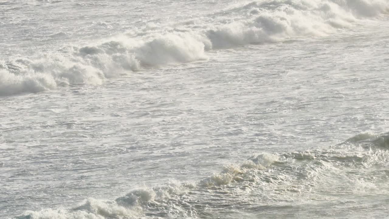 Dynamic ocean waves crash against the shore, captured in natural light along Australia's scenic Great Ocean Road