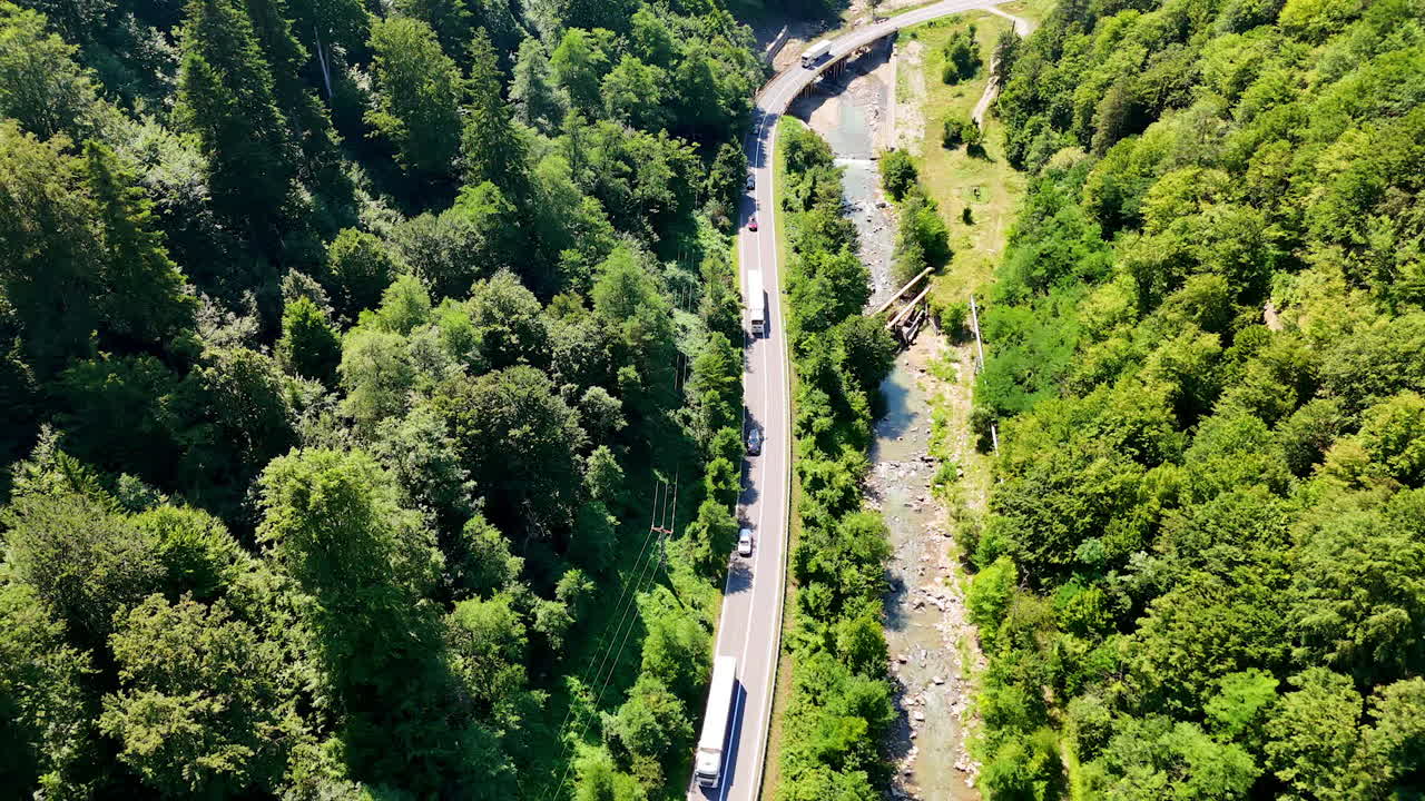 Green grass covering the alpine highland. Lush vegetation grows on the rolling terrain near the mountain edge