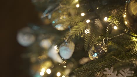 close-up view of a christmas tree with christmas decorations hanging