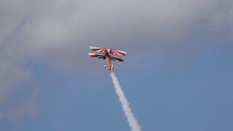 biplane performs aerobatics figures. airshow