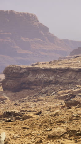 vast desert landscape at dusk reveals rugged cliffs and dramatic formations
