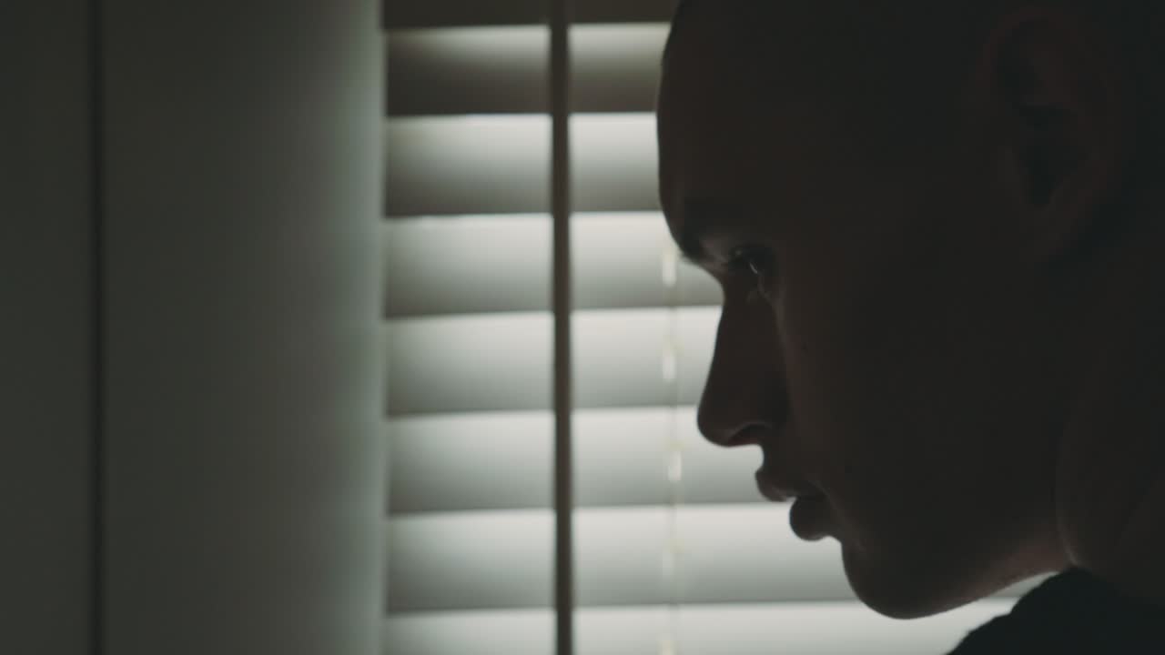Silhouette Of A Man Looking Outside The Window - Closeup Shot