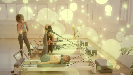 exercising on pilates reformers, people surrounded by glowing bubbles animation