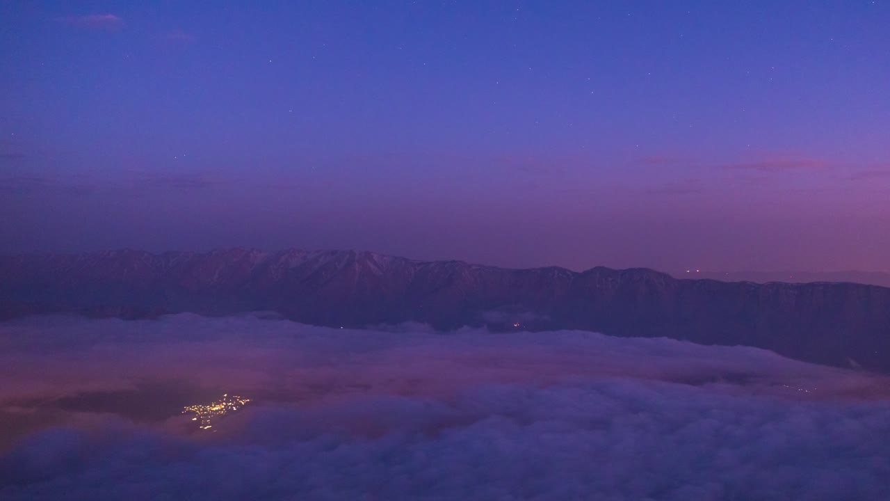 Experience twilight glow from an airplane flying high above illuminated city lights with stunning aerial views of Iran Saudi Arabia Emirates under night sky twilight mountain landscape tehran