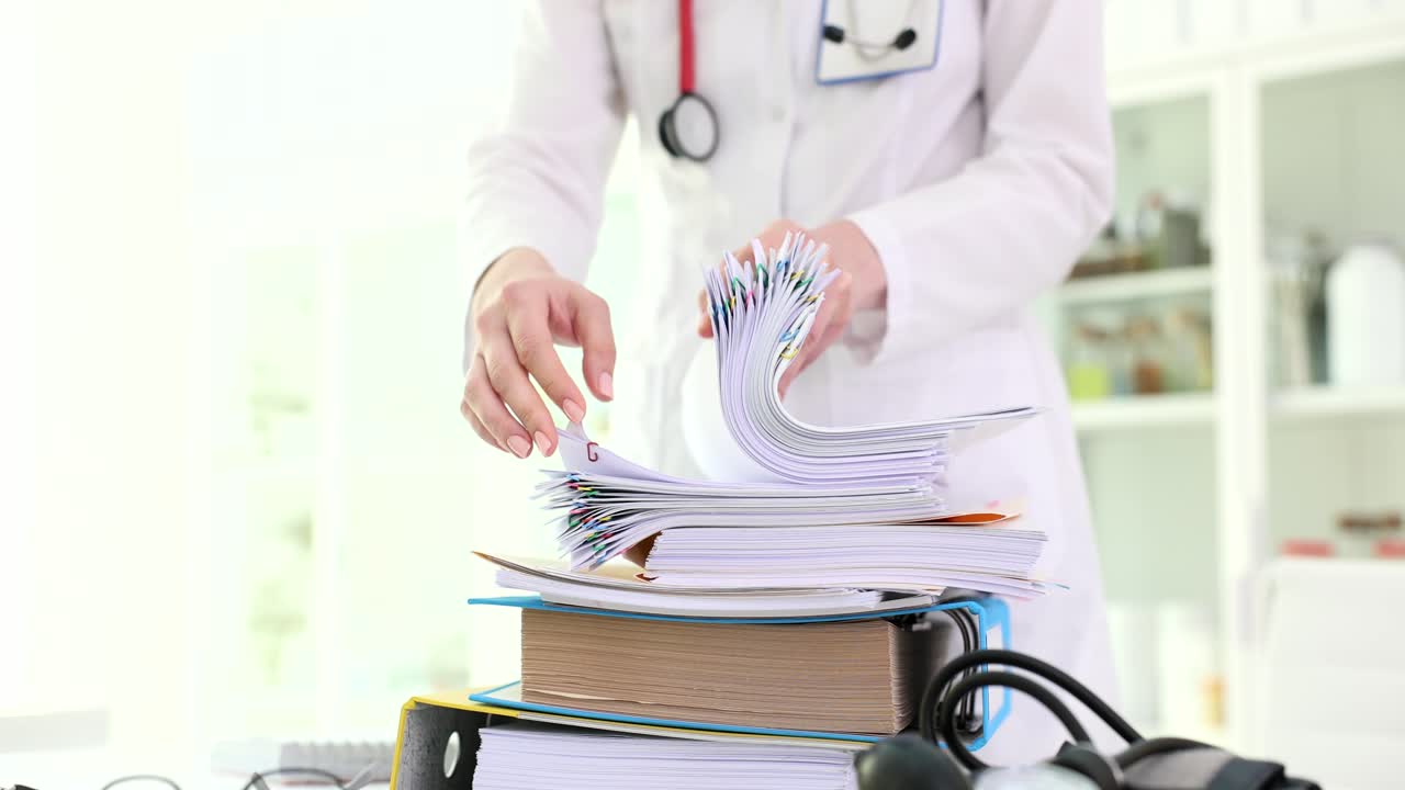 Medical professional organizing patient files and documents