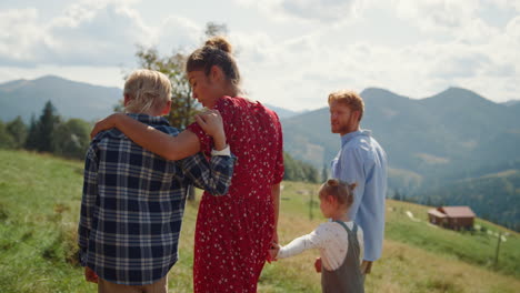 Umarmende-Familie-Genießt-Den-Spaziergang-Am-Grünen-Hang-An-Einem-Sonnigen-Tag.-Menschen-Verbringen-Urlaub.