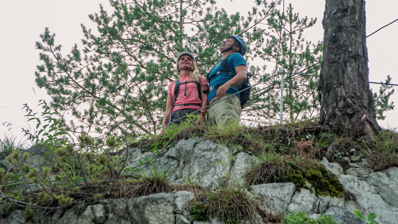 Man and women look out over nature. Point at something they like. Outdoor adventure. Slovenia