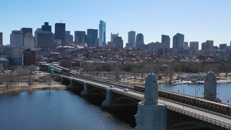 aerial establishing city skyline of boston massachusetts with longfellow bridge and subway train crossing 3