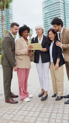 business team collaborating on a tablet outdoors in the city