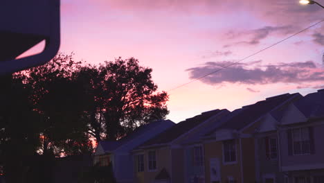 a beautiful sunset near a series of pastel color houses in a tropical setting in florida, calm and relaxed environment