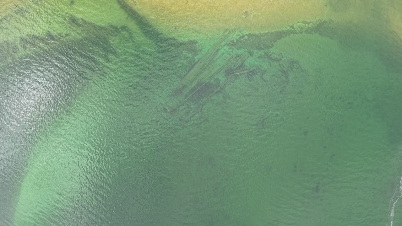 Aerial drone footage of shallow green-blue waters with visible sandbars and underwater textures in Michigan’s Upper Peninsula, Les Cheneaux Islands
