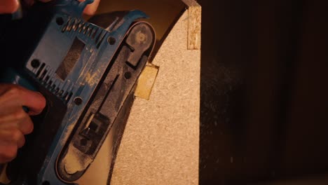 belt sander in action on wood project