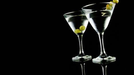 Two-cocktail-glasses-garnished-with-green-olives