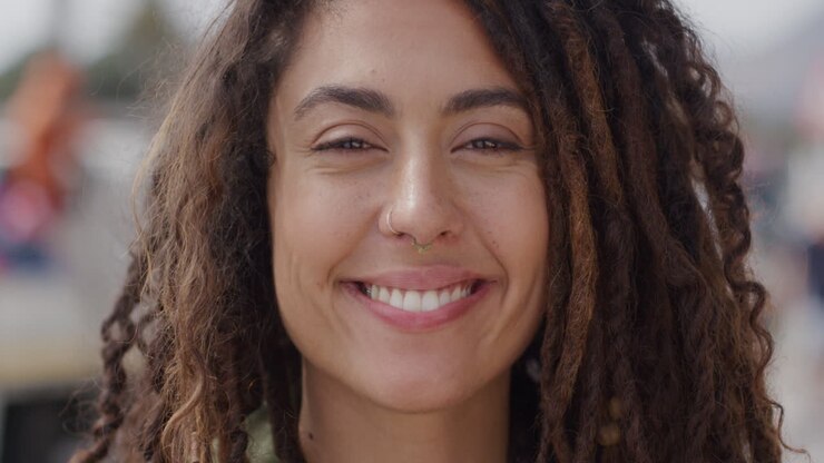 Portrait mixed race woman with dredlocks smiling