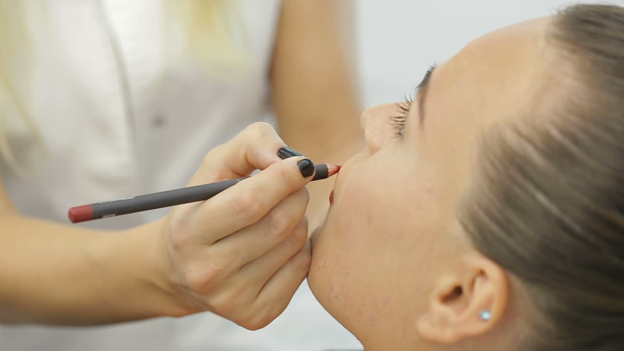 Permanent Make-up on her Lips. Portrait of lovely young woman getting permanent makeup on her lips