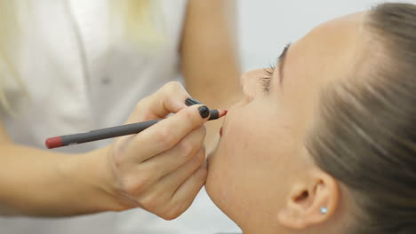 permanent make-up on her lips. portrait of lovely young woman getting permanent makeup on her lips
