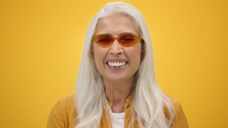 cheerful senior woman laughing indoors. smiling lady enjoying life in studio.