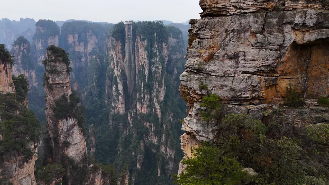 Tall sandstone pillars rise above the valleys in Zhangjiajie, creating a stunning natural landscape that feels surreal and awe-inspiring. Inspired the floating mountains in the movie Avatar.