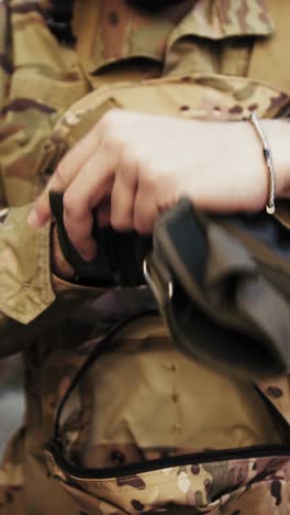 soldier puts on gloves before starting the operation in the city