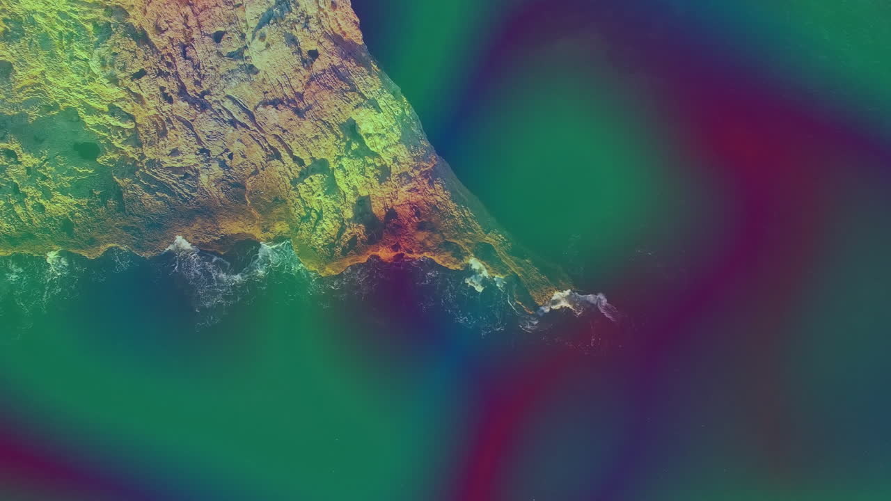 Animation of colorful abstract patterns swirling over rocky coastline and ocean waves