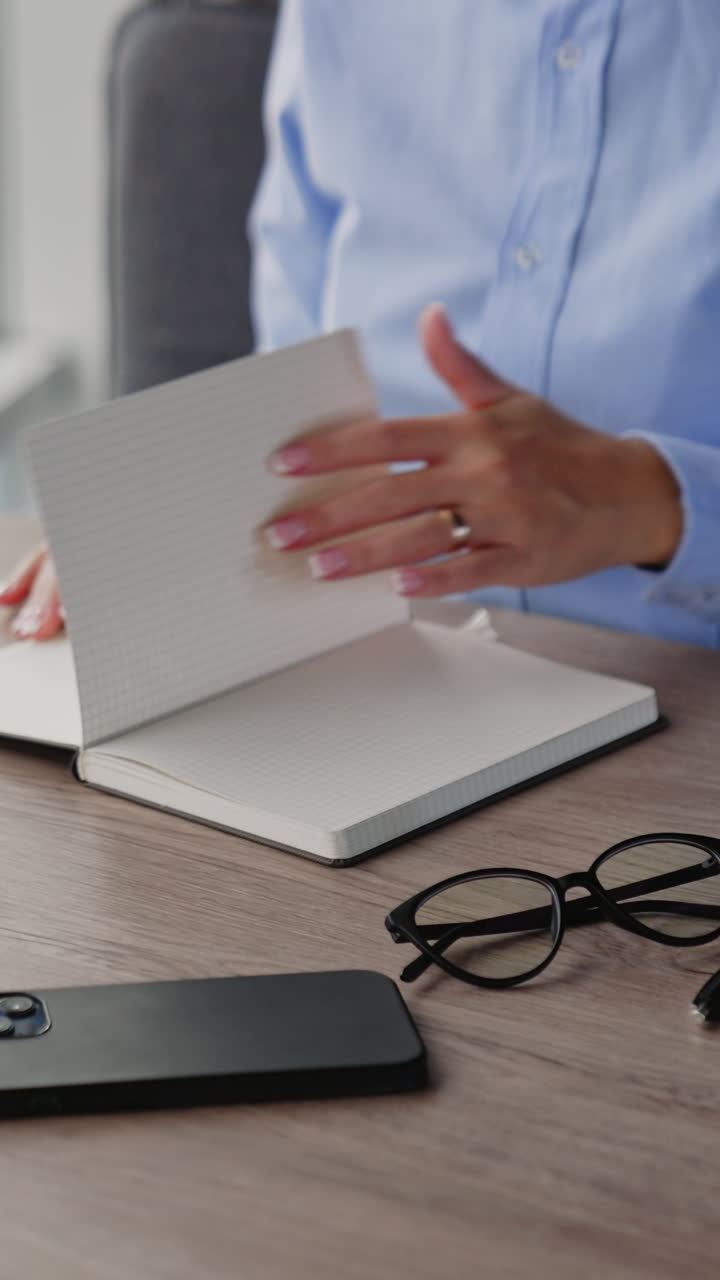 Business worker in modern styled office. Pretty businesswoman working with cellphone. Vertical video