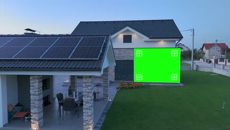 a modern house with solar panels and a green screen for real estate advertisement purposes - high angle shot